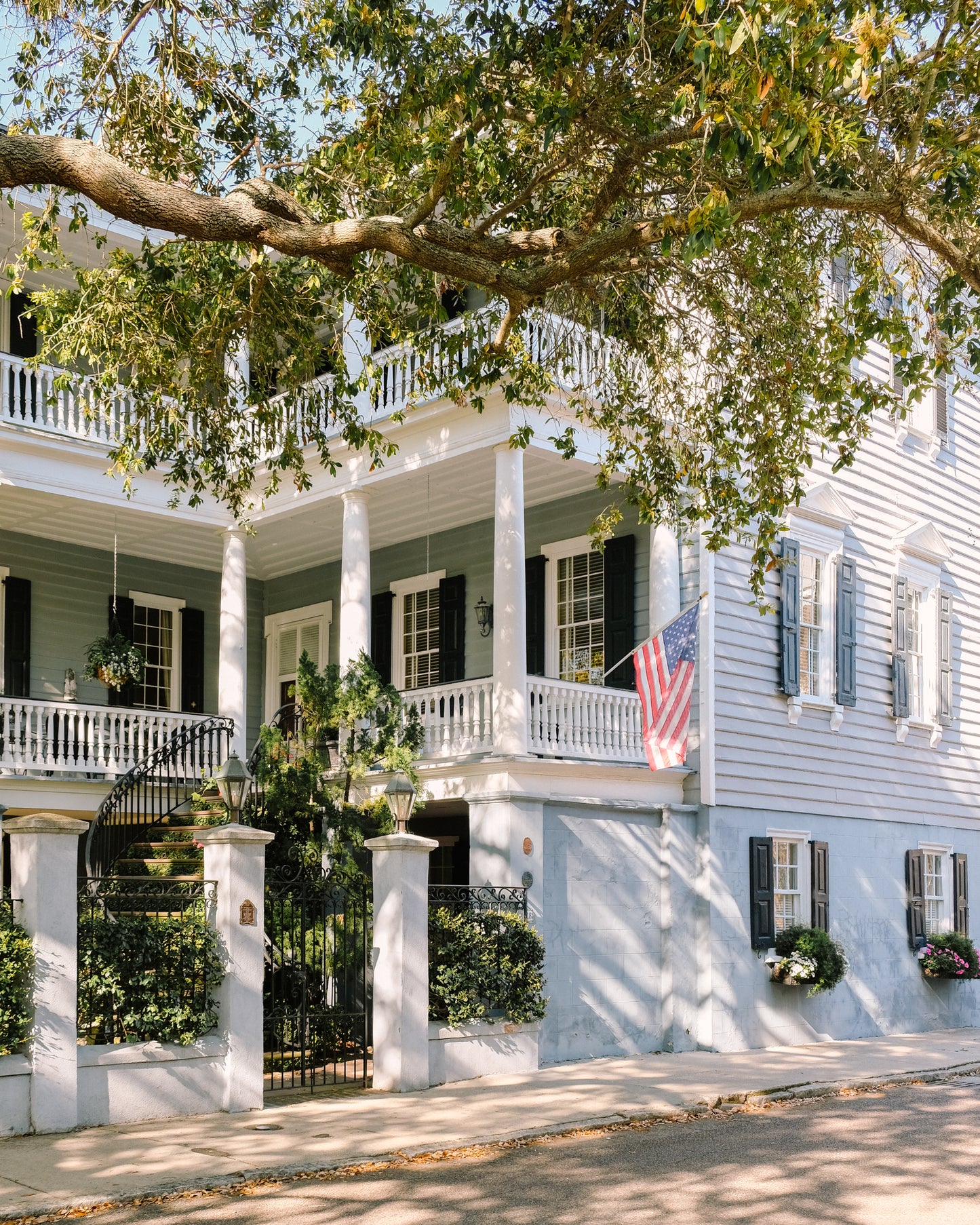 Charleston home with soft blue shutters and door – coastal photography print by Kelsey Bird