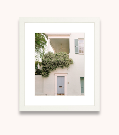 Framed wall art featuring a blue door and jasmine flowers in Charleston