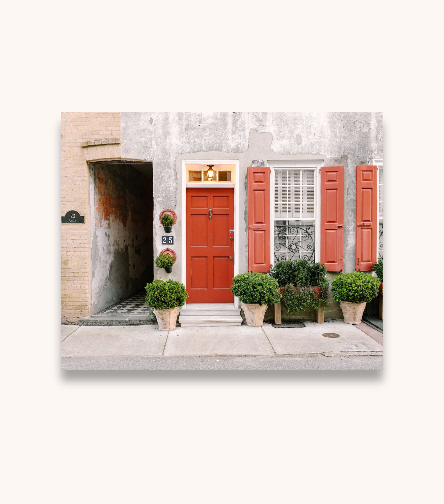 Charleston photography print of a red door on Queen Street displayed as unframed wall art