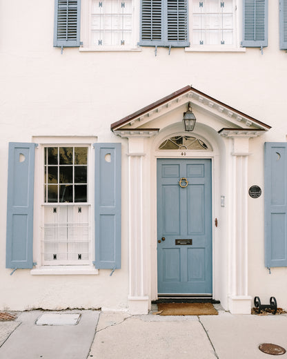 Blue Charleston door with crescent moon detail and matching shutters