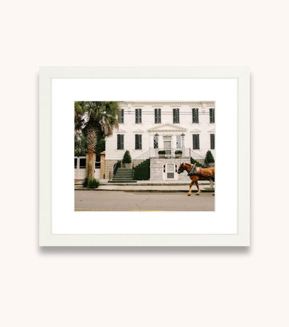 Framed Charleston wall art featuring a horse-drawn carriage and historic architecture