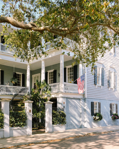 Blue Charleston home with white columns and classic Southern architecture