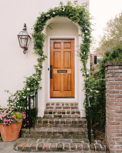 Ivy and flowering vines surrounding a historic King Street doorway in Charleston
