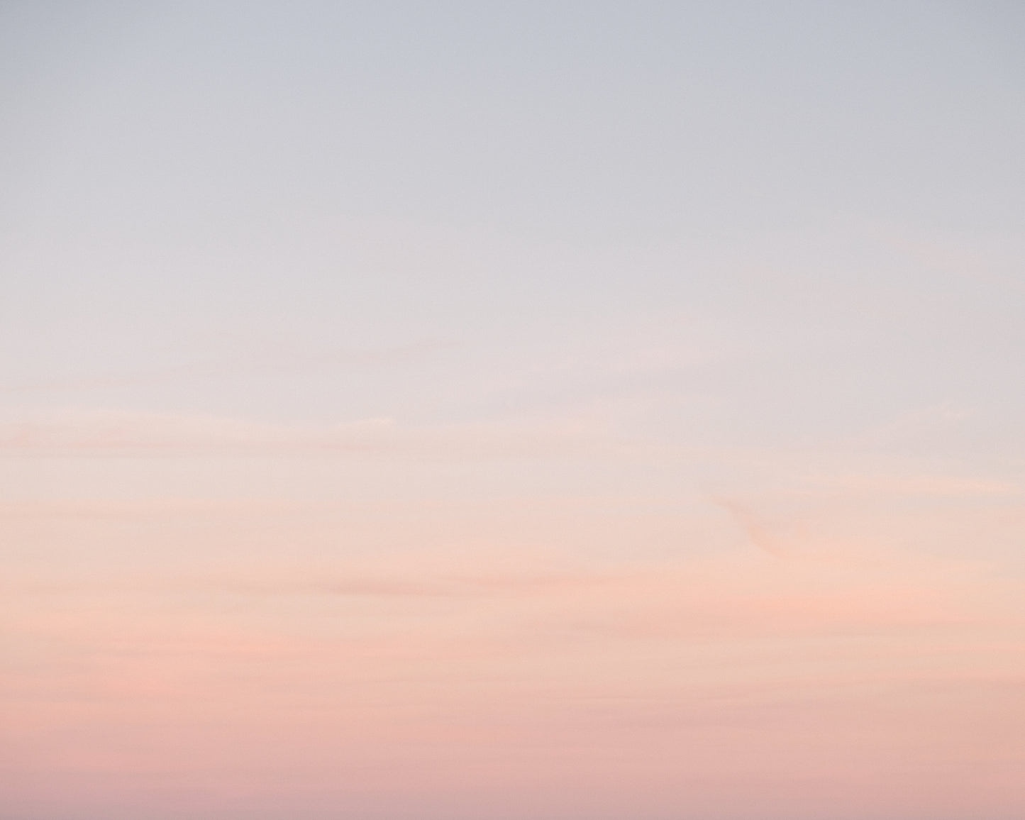 Soft pastel ombre sky at sunset in Charleston blending pink and blue tones