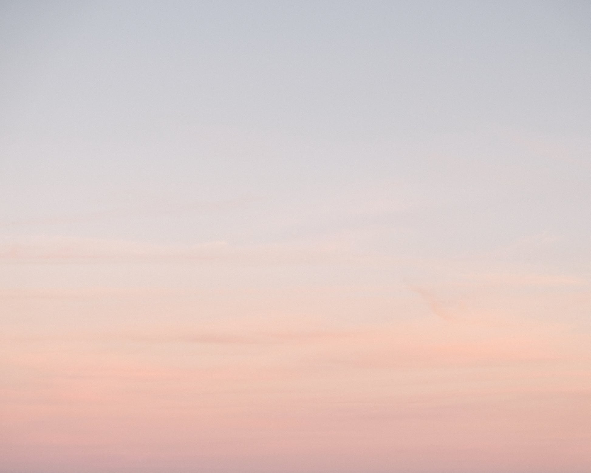 Soft pastel ombre sky at sunset in Charleston blending pink and blue tones