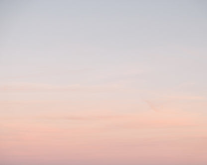 Soft pastel ombre sky at sunset in Charleston blending pink and blue tones