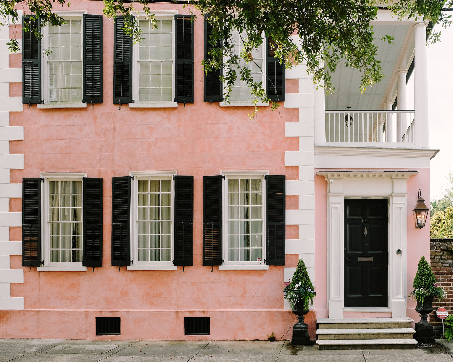 Pink house with black shutters on Tradd Street in Charleston’s South of Broad neighborhood