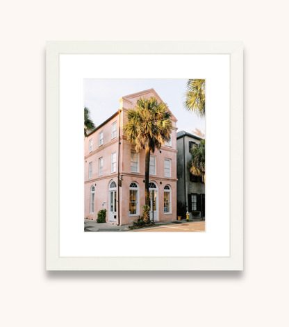 Framed wall art featuring Charleston palmetto trees and pastel architecture