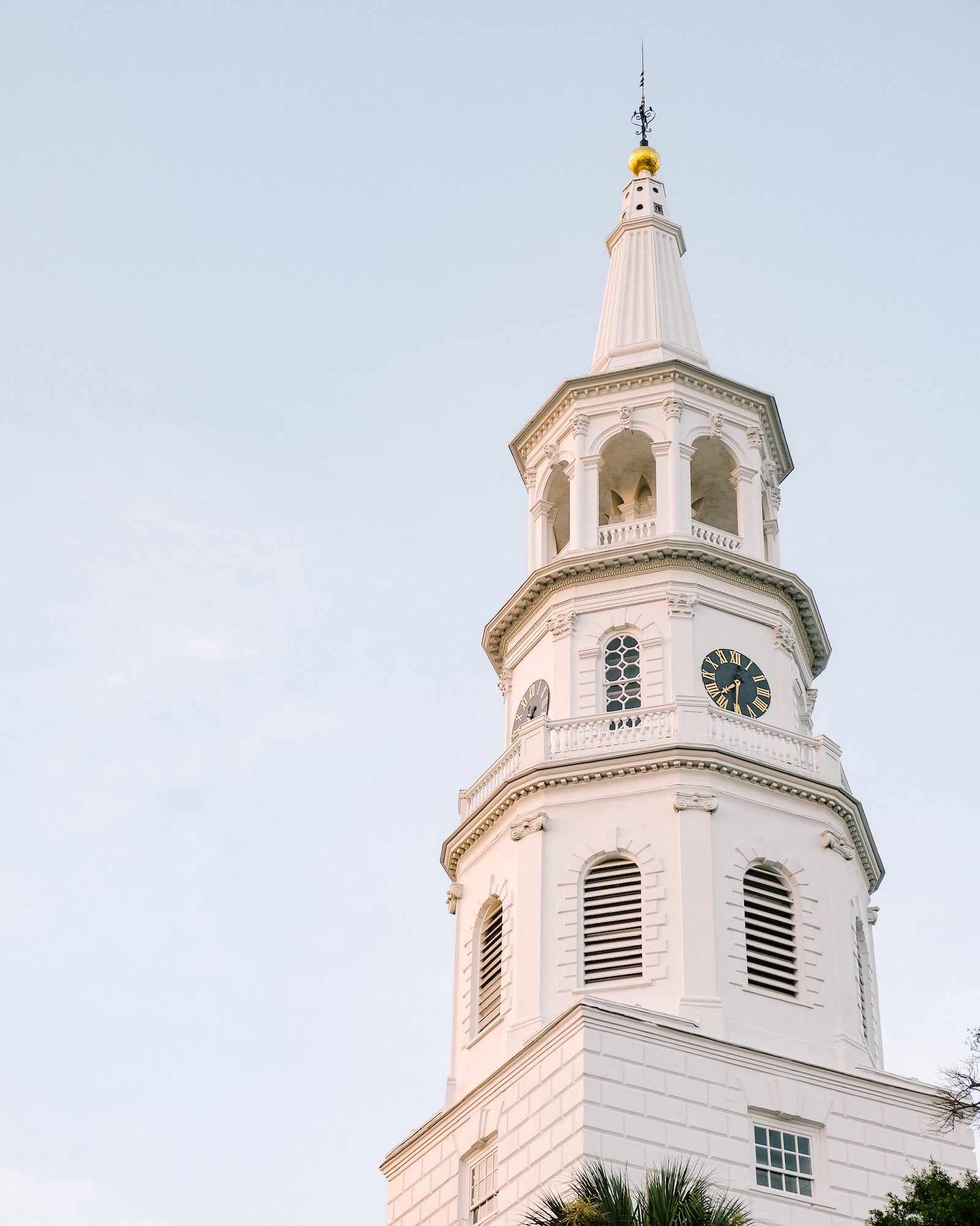 St. Michael’s Church steeple rising above Charleston with classic Georgian architecture and a soft blue sky