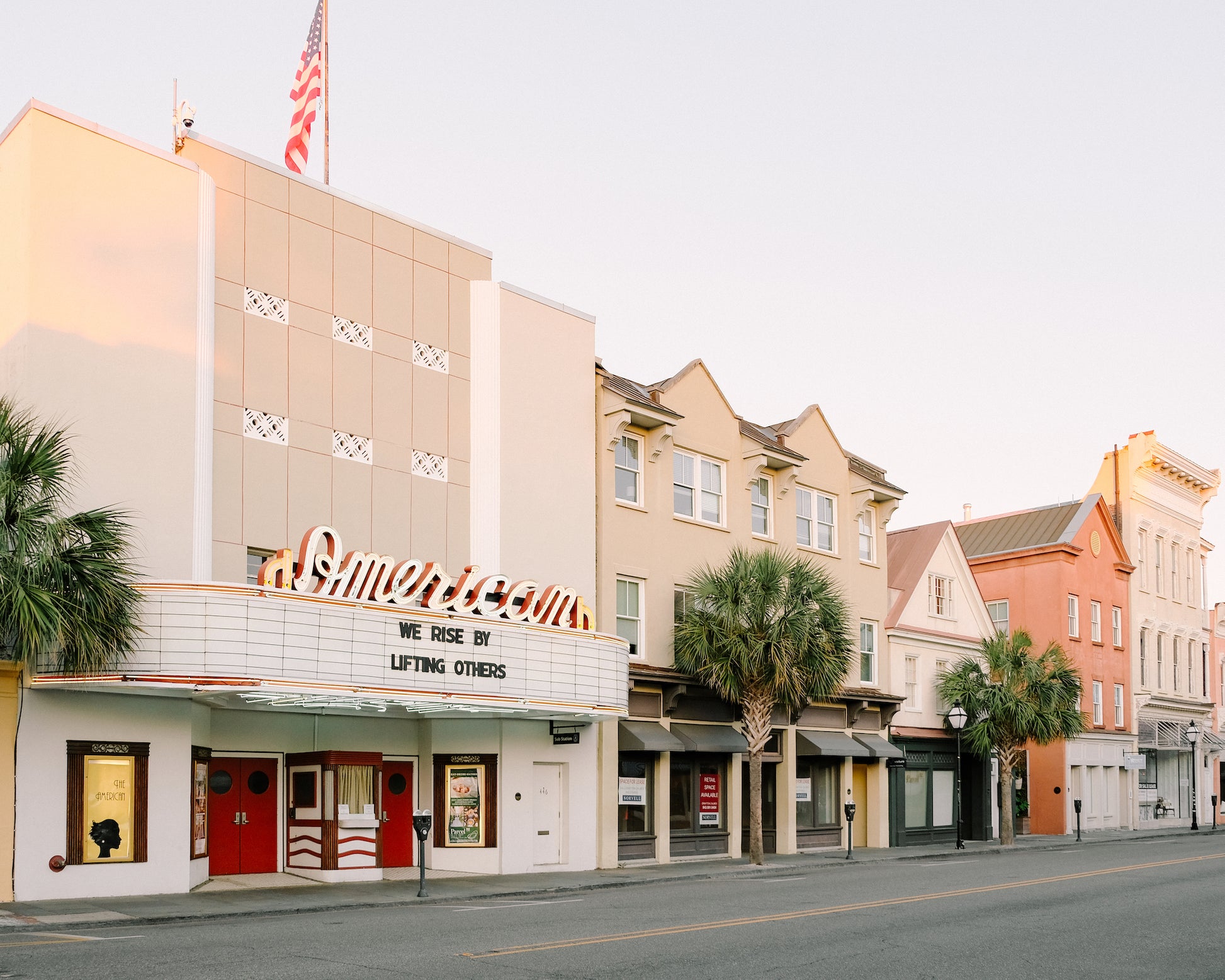 American Theater on King Street in downtown Charleston with marquee reading “We rise by lifting others” in soft morning light