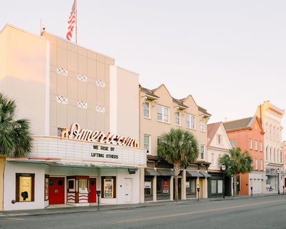 American Theater on King Street in downtown Charleston with marquee reading “We rise by lifting others” in soft morning light