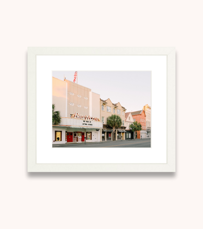 Framed Charleston wall art featuring the American Theater on King Street with “We rise by lifting others”